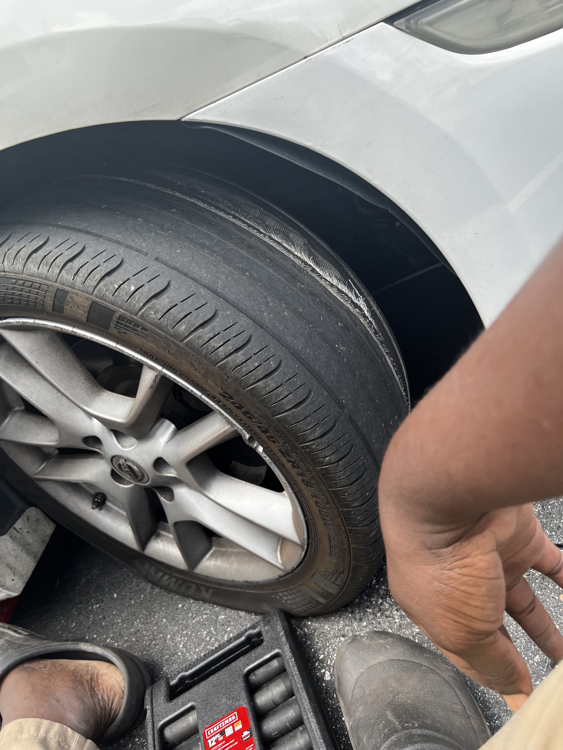 Roadside tire service being completed on a vehicle